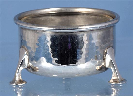 A George V Arts & Crafts silver three piece condiment set,